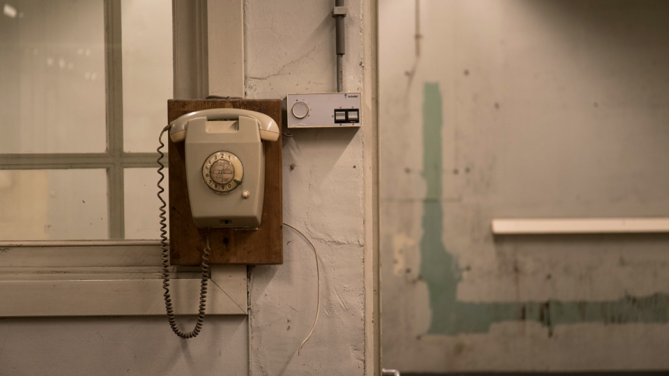 Old telephone hung on wall