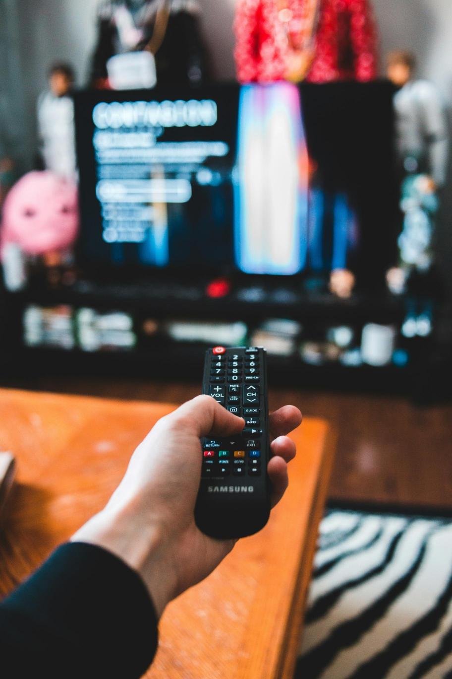 Person using remote control for TV