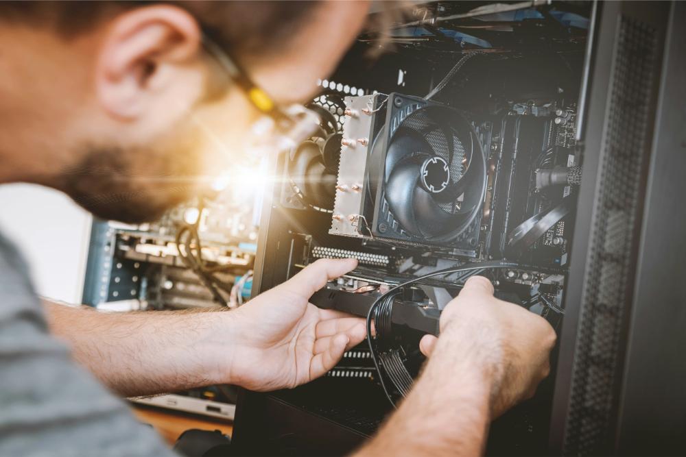 Man working on fixing a computer or hardware