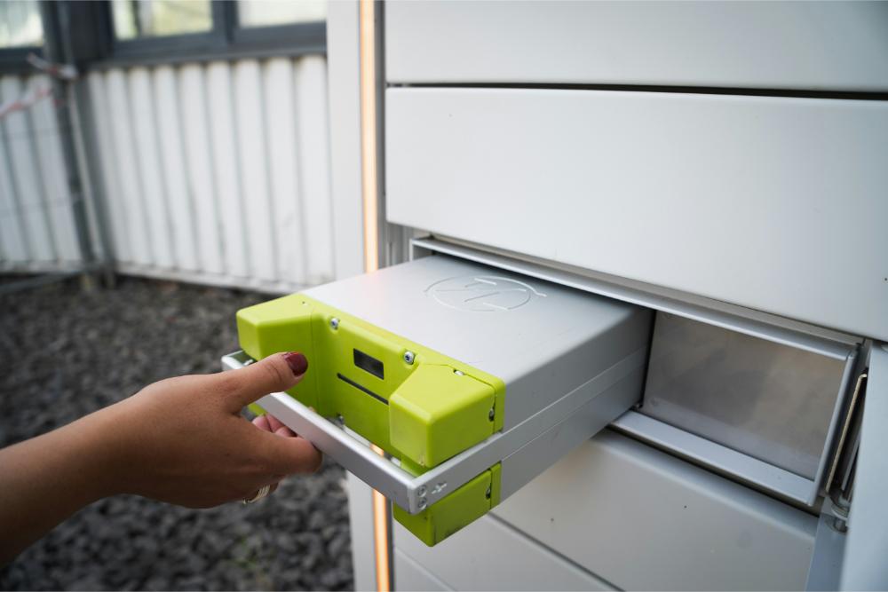 woman pulling a drawer out of a metal locker