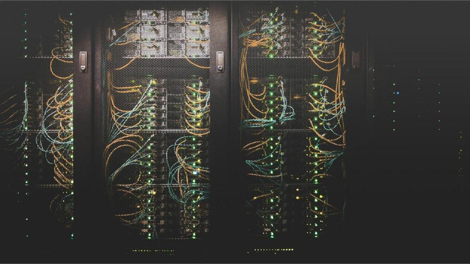 row of servers in a dark room