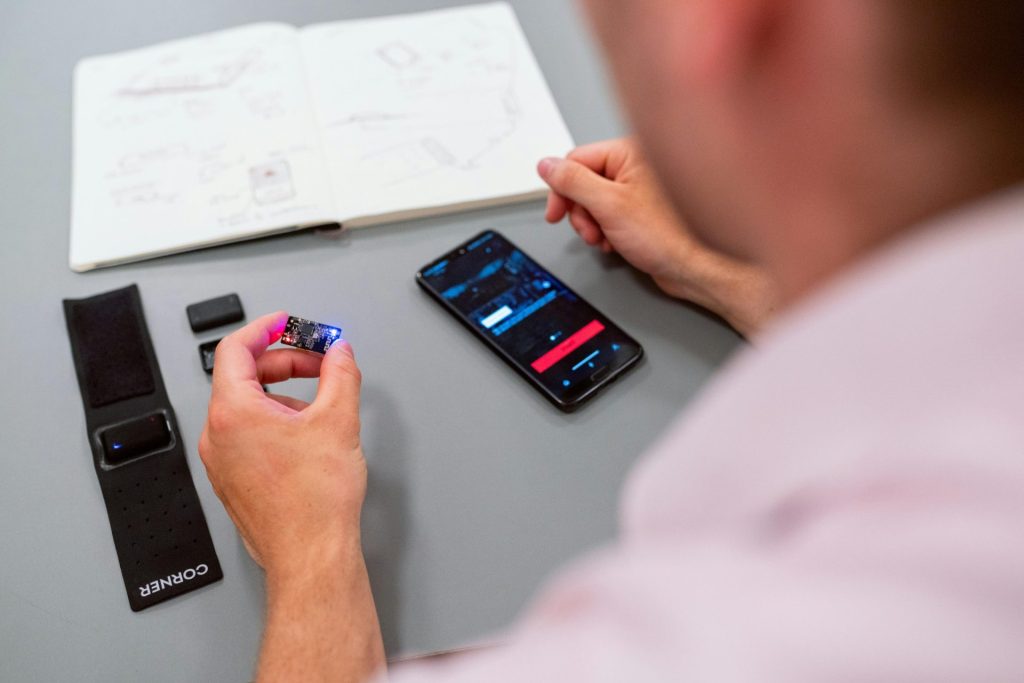 Man holding hardware and working on phone